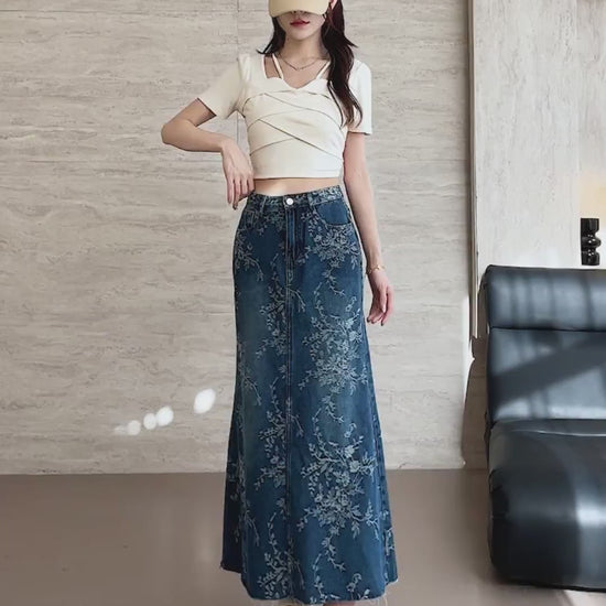 YEEYEEWang Denim Maxi Skirt video in Blue: Asian model walks, poses hands-on-hips, pockets and leg-lift, showing high-rise A-line drape and floral ankle hem.
