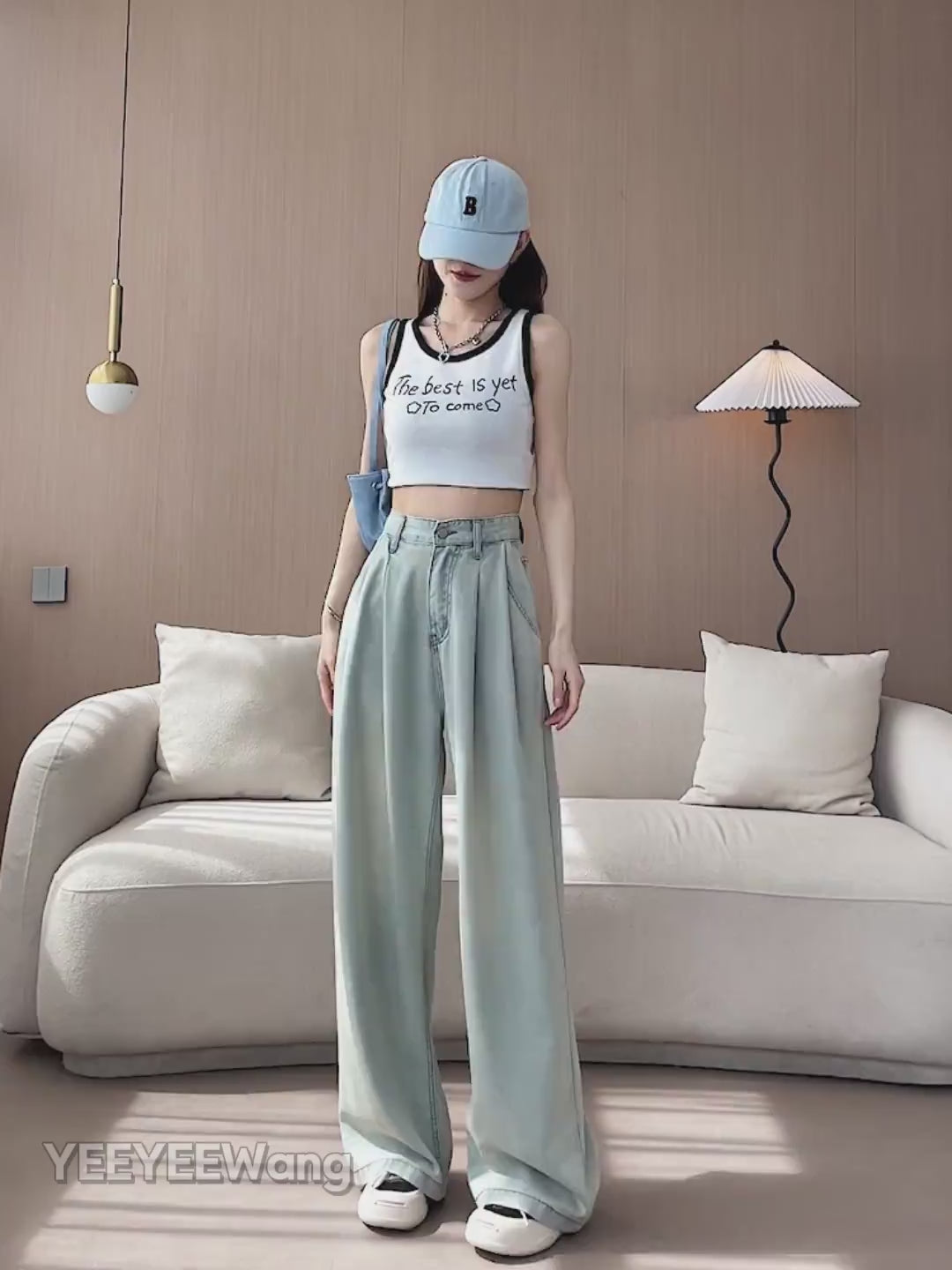 YEEYEEWang Wide-Leg jeans video: Asian model in Light Blue stands with hands in pockets and lifts leg, camera zooms in on high waist, front pockets and relaxed stacking hem with soft draping fabric